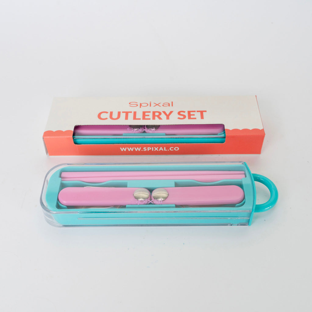 Pink cutlery set with teal case on a white background