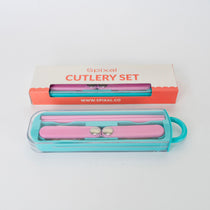 Pink cutlery set with teal case on a white background