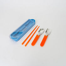 Set of orange cutlery with blue case on a white background
