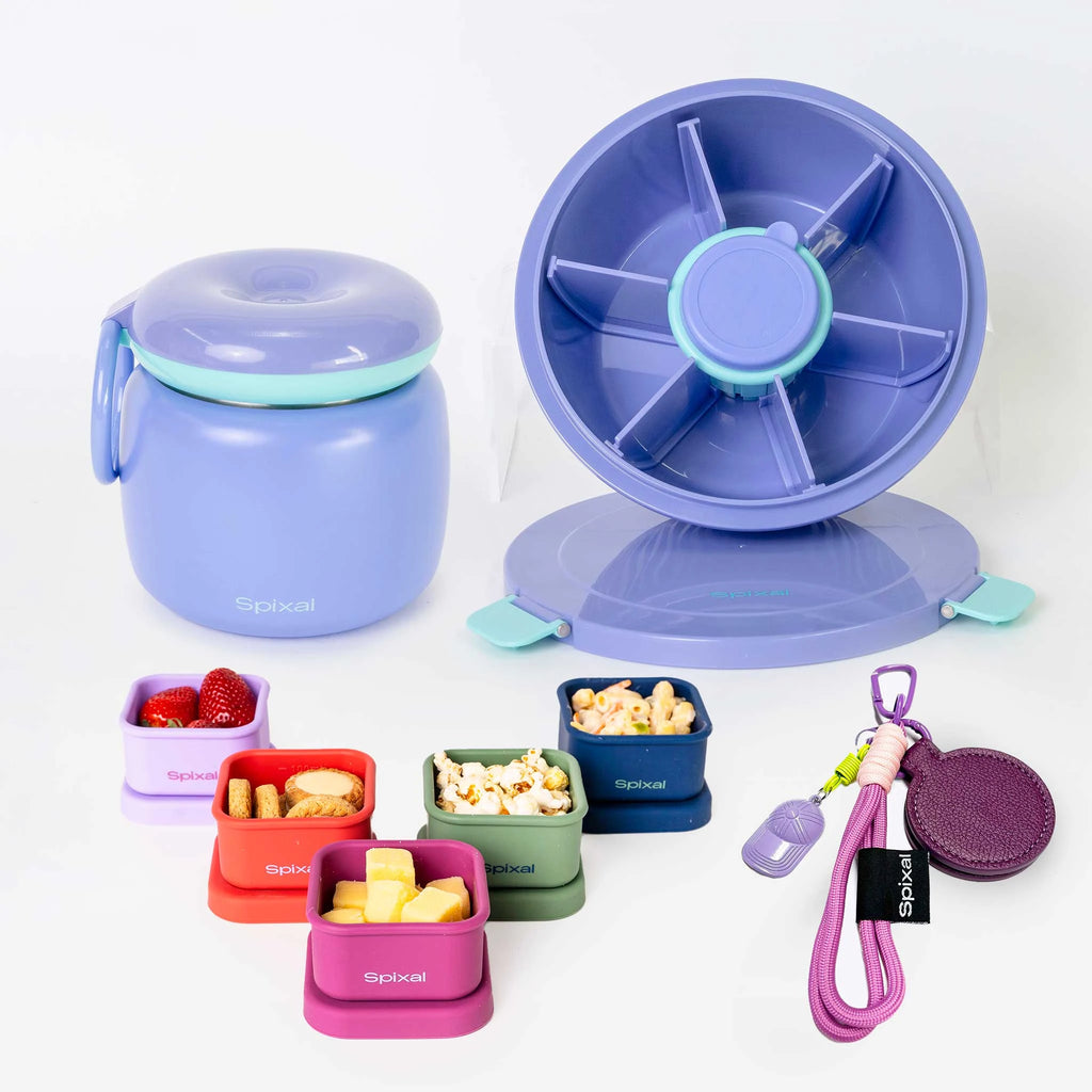A set of Spixal lunch containers and accessories on a clean white background, including a purple insulated food jar with teal trim, a purple spinner lid, smaller colourful containers with food samples, a purple magnetic hat clip.