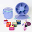 A set of Spixal lunch containers and accessories on a clean white background, including a purple insulated food jar with teal trim, a purple spinner lid, smaller colourful containers with food samples, a purple magnetic hat clip.