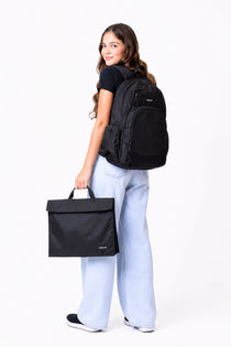 Large black Axis school bag and homework folder carried by school girl matching set | Spixal