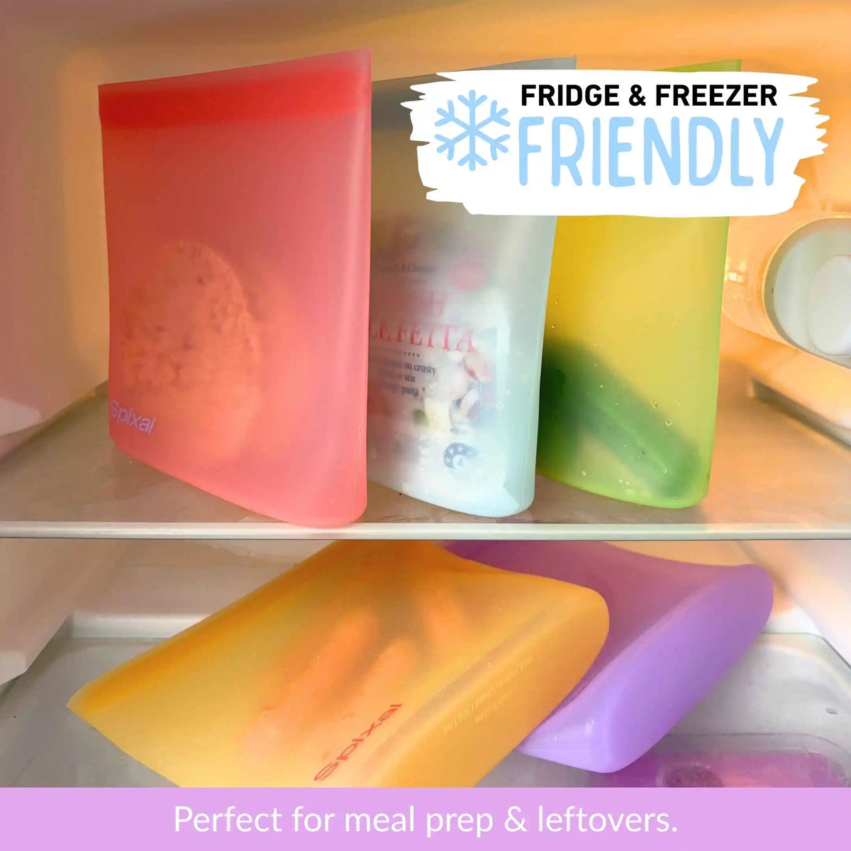 Five reusable silicone food sandwich and snack bags in red, blue, green, yellow and purple shown inside a refrigerator shelf, with text overlays reading 'FRIDGE & FREEZER FRIENDLY' and 'Perfect for meal prep & leftovers.'.