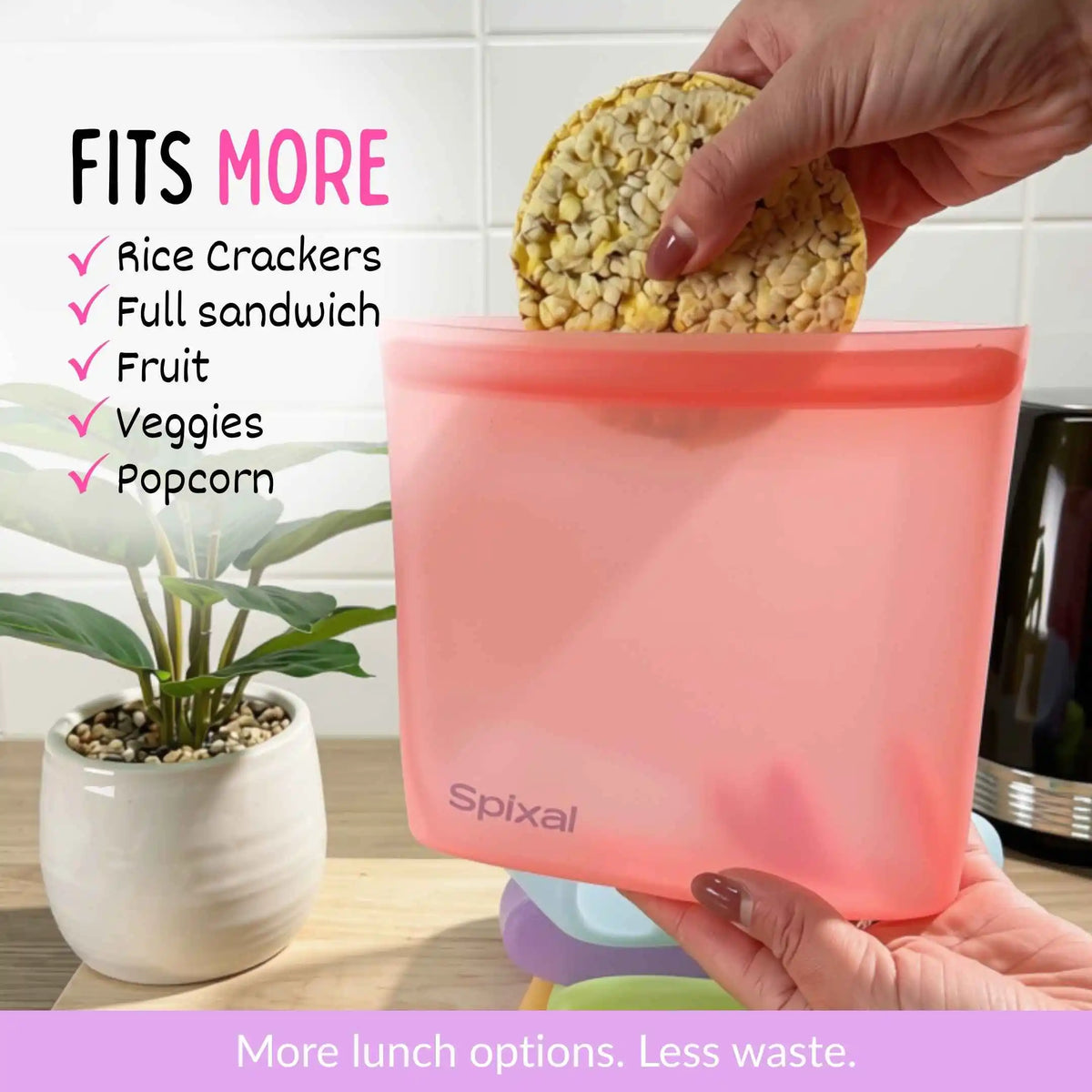 A translucent red Spixal food snack bag being held by hands, with a rice cracker being placed into the top opening. The image includes promotional text on the left listing foods it fits (rice crackers, full sandwich, fruit, veggies, popcorn) and a purple banner at the bottom. More lunch options. Less waste.