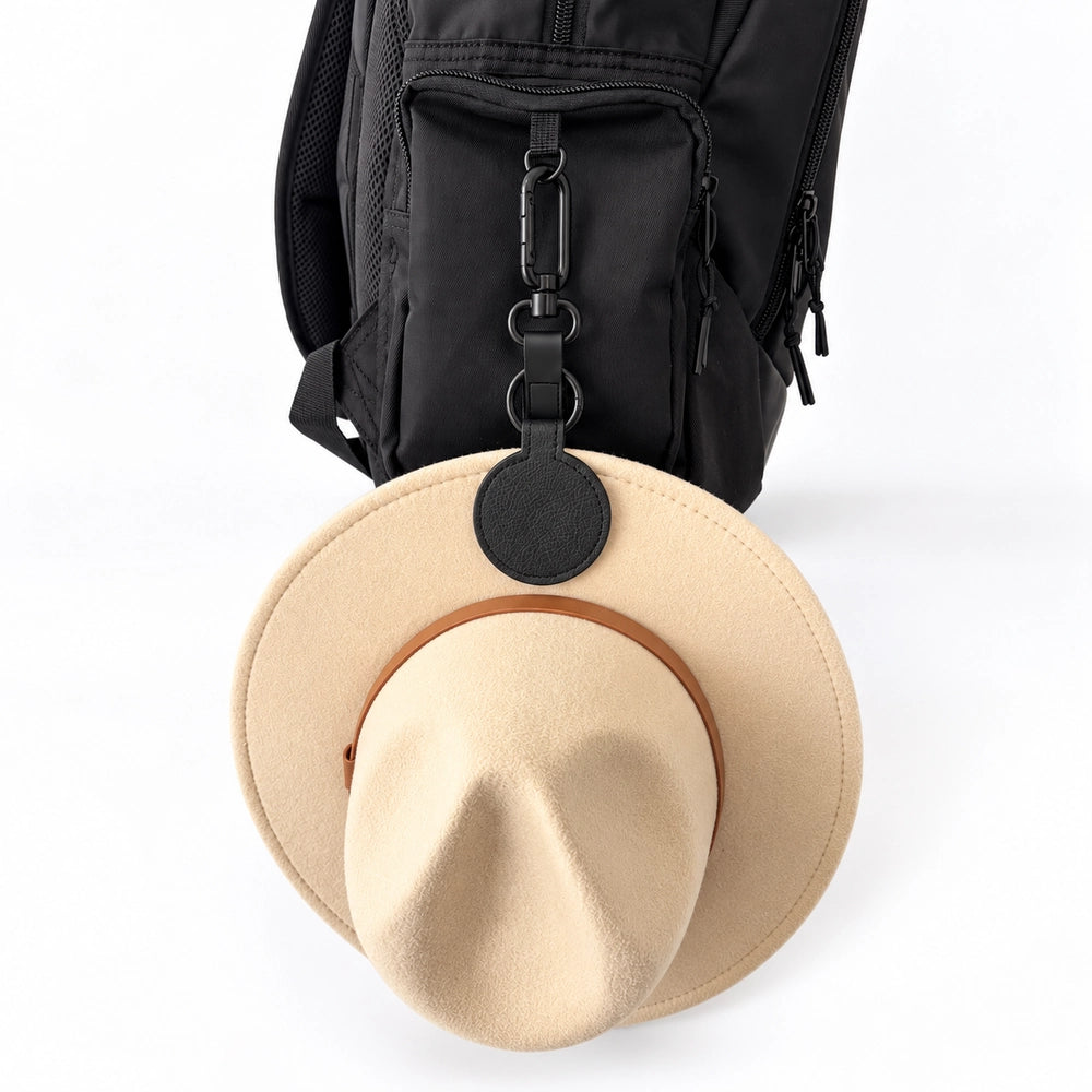 Black magnetic hat clip keeping a school hat on the outside of a kids backpack | Spixal