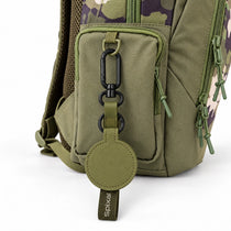 Green Axis magnetic hat clip on a camo kids school backpack | Spixal