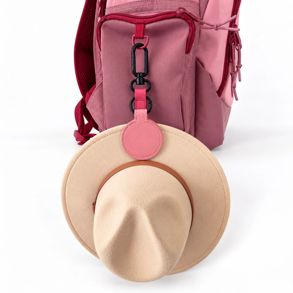 Pink magnetic hat clip holding a school hat on a girls school backpack | Spixal