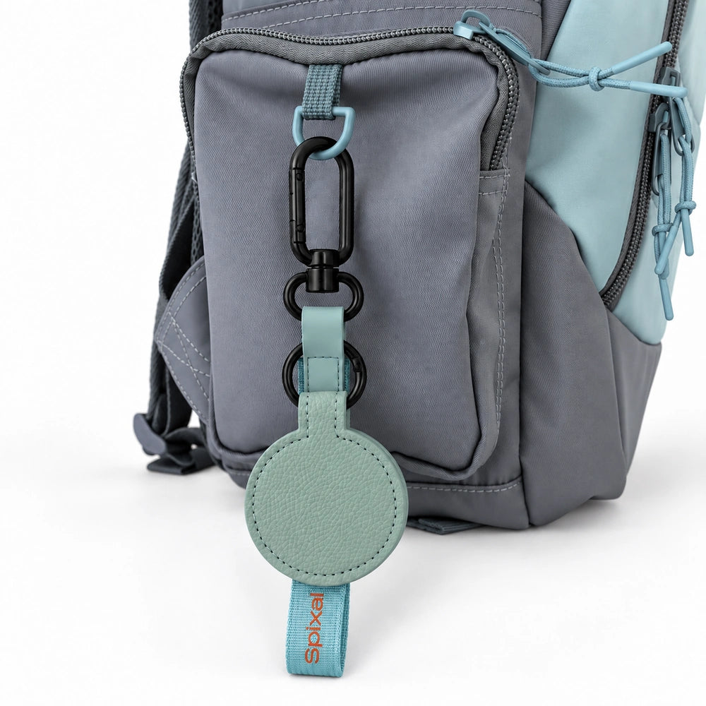 Teal Axis magnetic hat clip on a green and grey kids school backpack | Spixal