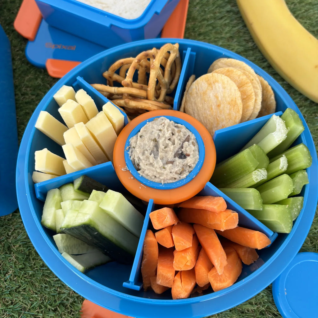 Blue Roundie bento lunch box packed with crackers, veggie sticks and dip