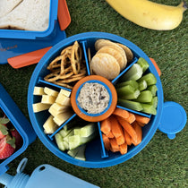 Blue Roundie bento packed with six snacks around a centre dip pot