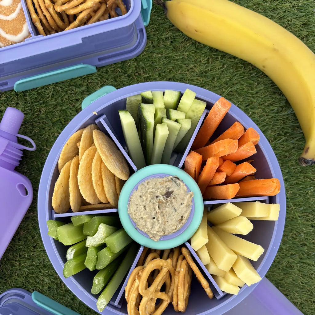 Purple Roundie bento packed with snacks and a centre dip pot