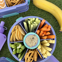 Purple Roundie bento packed with snacks and a centre dip pot
