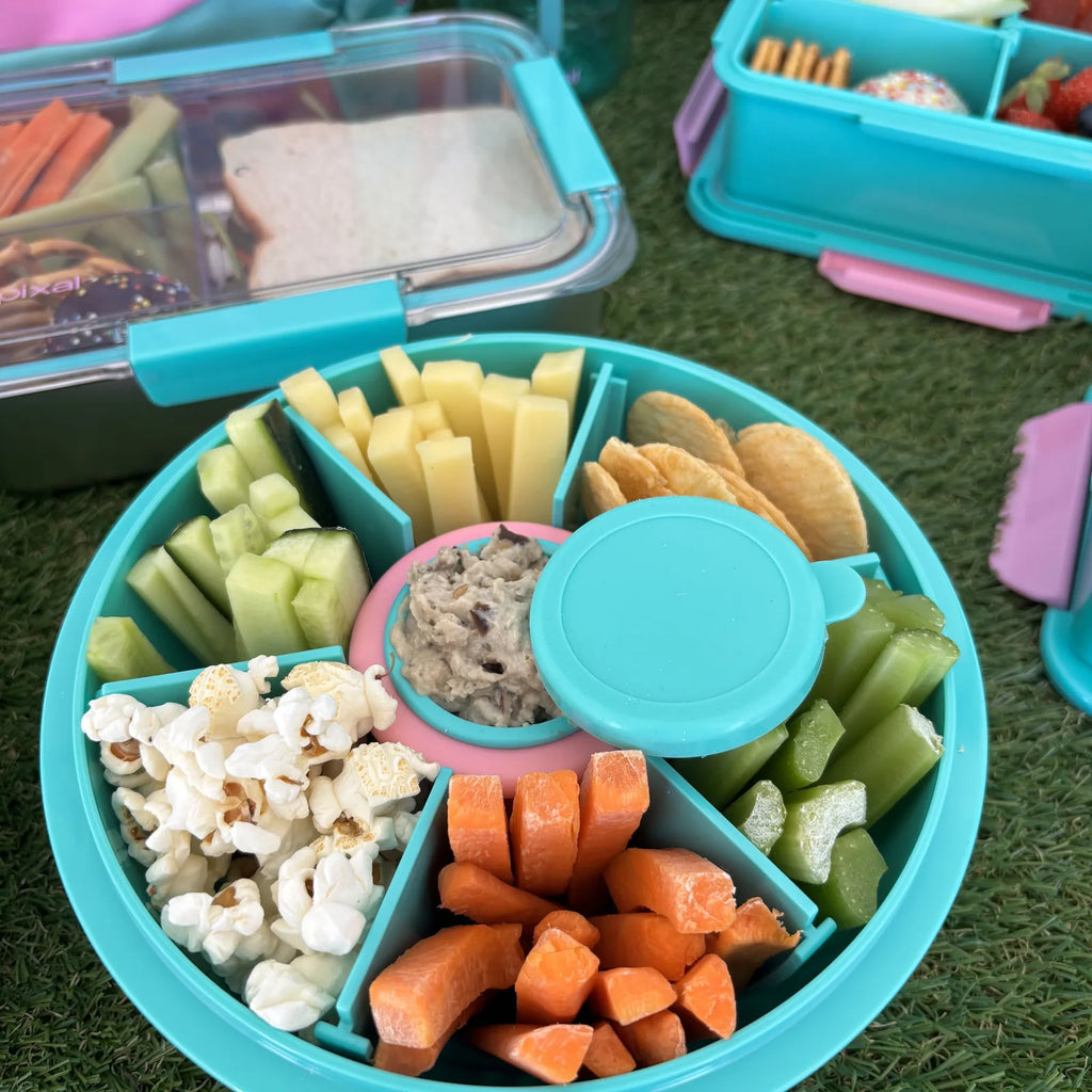 Teal Roundie bento with six snack compartments and lid on the centre dip pot